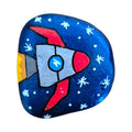 Hand painted rocketship flying through a starry night sky on a rock