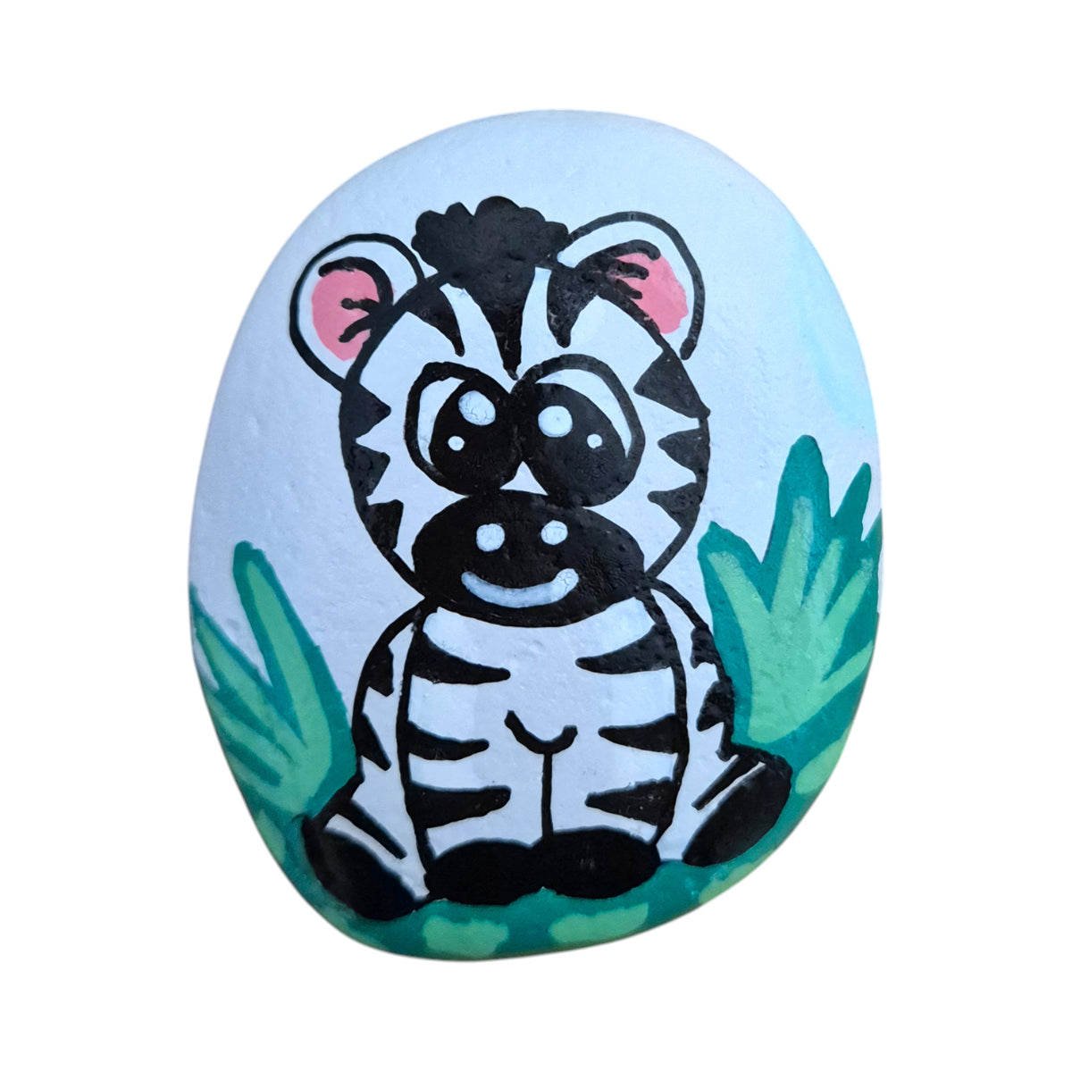 Hand painted baby zebra standing in grass on a natural stone rock