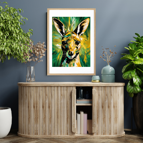 Abstract kangaroo artwork in green and yellow tones displayed in a natural wood frame on a wall above a light wooden cabinet.