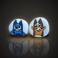 Pup Pals, a set of 2 hand painted rocks: a blue pup and a red pup, on a black and gold background