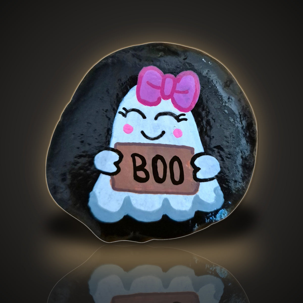 Boo-tiful, a hand painted ghost rock with a pink bow holding a boo sign, on a black and gold background