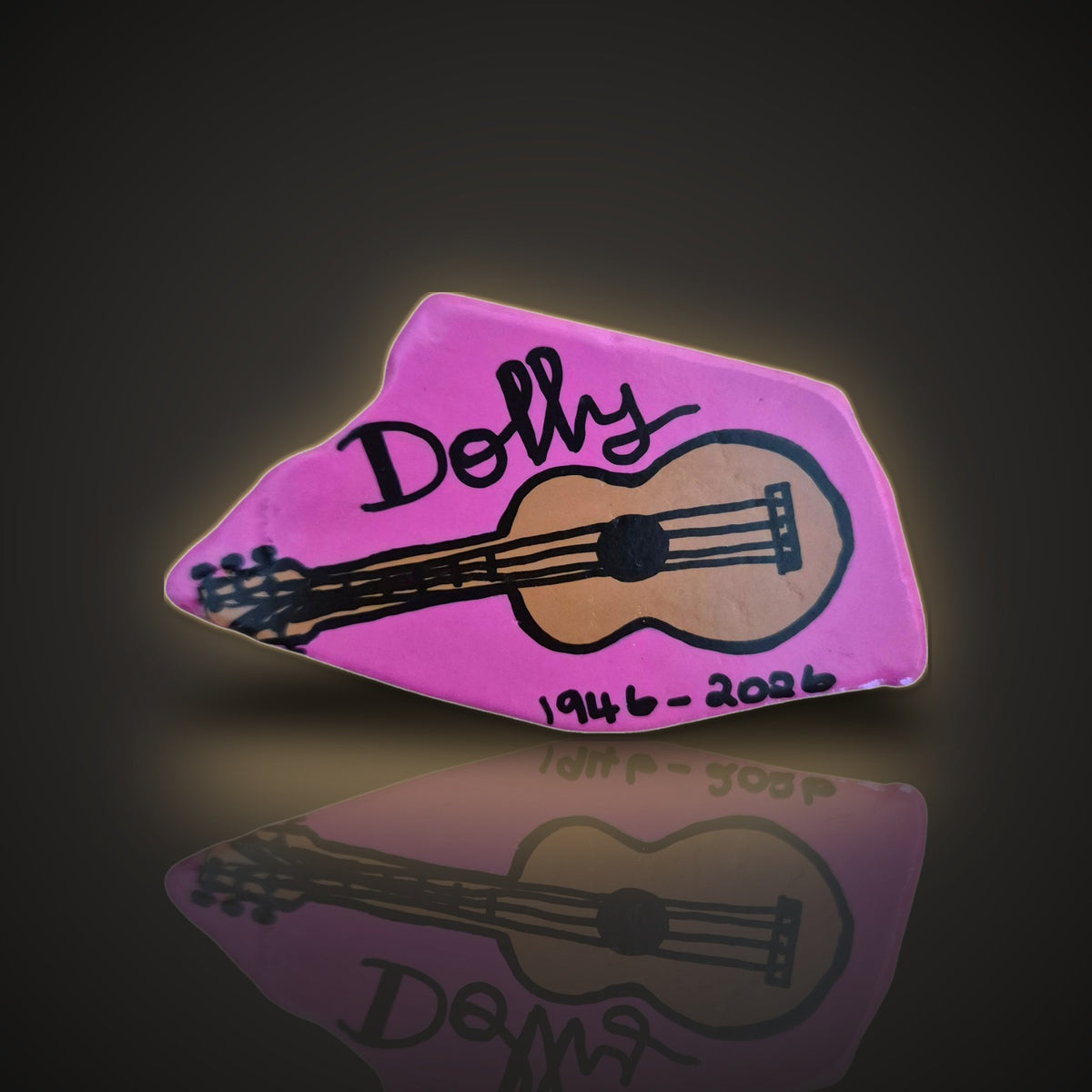 Strum Queen, a hand painted guitar tribute rock with the years 1946-2026, on a black and gold background