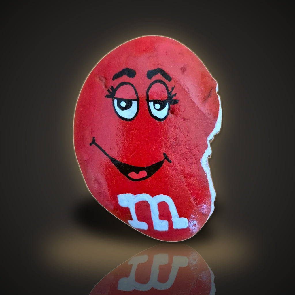 Nibbles, a hand painted half-eaten red candy rock, on a black and gold background