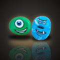 Monster Mash, a set of 2 hand painted monster rocks, one green and one blue, on a black and gold background