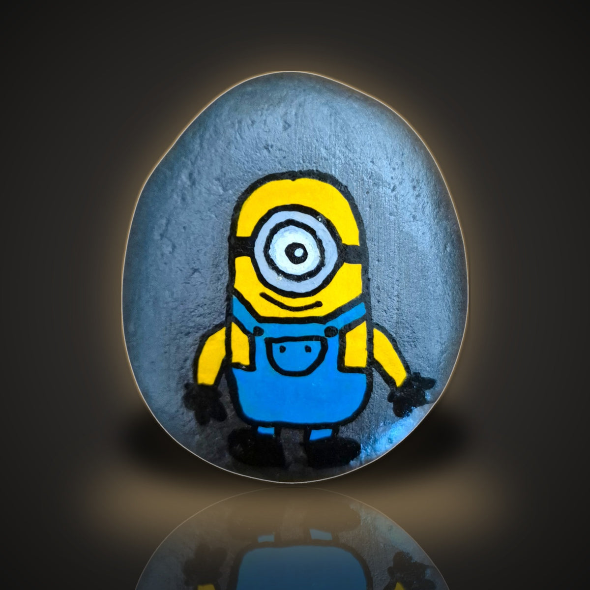 Winky, a hand painted one-eyed yellow character rock, on a black and gold background