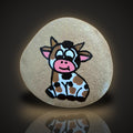Glitter Moo, a hand painted cow rock on a sparkling glitter background, on a black and gold backdrop
