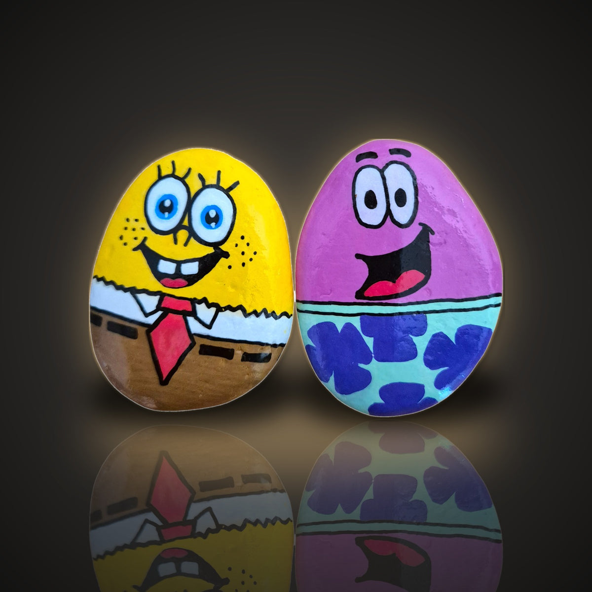 Sea Pals, a set of 2 hand painted rocks: a yellow sponge and a pink starfish, on a black and gold background